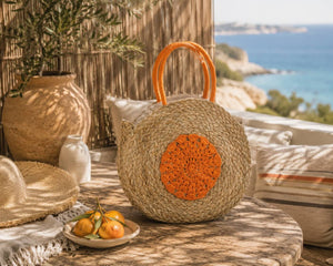 Sac de plage rond en jonc de mer avec motif floral, naturel/orange