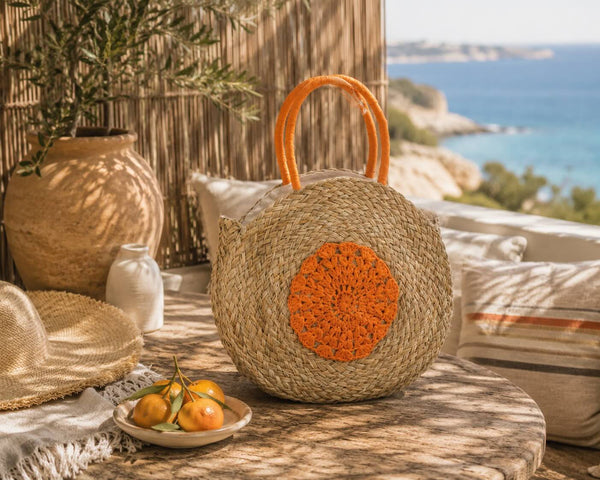 Sac de plage rond en jonc de mer avec motif floral, naturel/orange